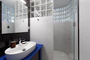 a bathroom with a white sink and a shower at The Baroness in Kalamata +33 photos
