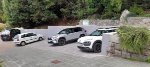a group of cars parked in a parking lot at Apartments Kiki in Opatija