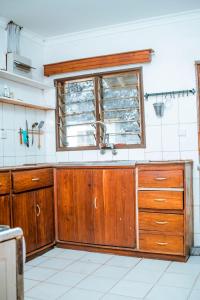 a kitchen with a sink and a window at Charming Bungalows in Mwanza