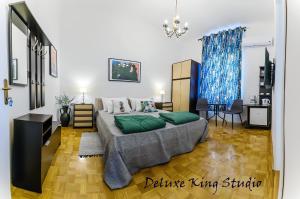 a bedroom with a large bed with green pillows at Summertime Apartments in Zadar