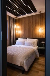 a bedroom with a large bed with a wooden wall at Jezyce Good Place Free Parking in Poznań
