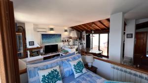 a living room with a couch and a television at Attico Vista Mare Trapani in Trapani