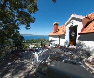 a house with a balcony with a view of the ocean at Bonavista Brela in Brela