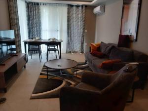 a living room with a couch and a table at Prime Homes Gambia Luxury Apartment in Sere Kunda