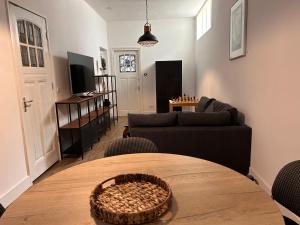 a living room with a table and a couch at Artistic apartment, City Centre Dordrecht in Dordrecht