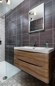 a bathroom with a sink and a mirror at The Stylish 3-Bedroom Maisonette Retreat in Stirling