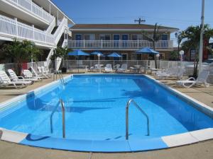 a large blue swimming pool in front of a hotel at Sea Garden Motel in Seaside Heights