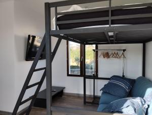 a living room with a bunk bed and a couch at Studio Pont du Gard in Sernhac
