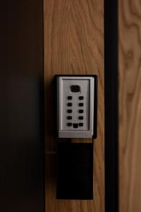 a close up of a hotel room door with an electronic device at Native Apartments Kościuszki 39 in Kraków