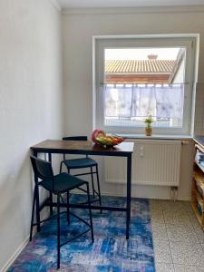 une table et des chaises dans une cuisine avec une fenêtre dans l'établissement Die 2eitwohnung, à Hochheim am Main