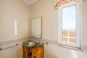 a bathroom with a sink and a window at Villa alhabu in Albufeira +18 photos