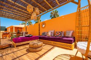 a patio with purple couches on a wooden deck at Villa alhabu in Albufeira