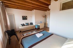 a bedroom with a bed and a couch in a room at Terre Boscaratto in Susegana
