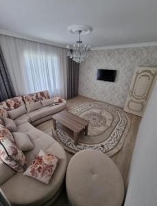 a living room with a couch and a table at Beautiful Villa in Qusar