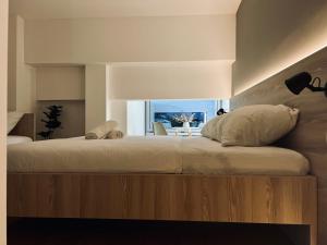 a bedroom with a large bed with a wooden headboard at Borsa Rooms in Mostar