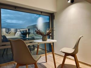 two chairs and a table in front of a window at Borsa Rooms in Mostar