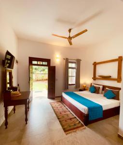 a bedroom with a bed and a desk in it at Dharma Place in Unawatuna