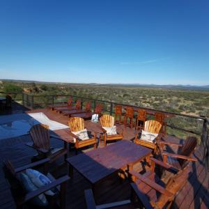 a deck with tables and chairs and a view of the desert at Osberg Safari's in Kirkwood