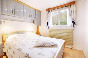 Schlafzimmer mit einem Bett und einem Fenster in der Unterkunft Le Chalet Sous les Sapins - Superbe vue in Rochesson
