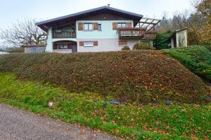 a house sitting on top of a grassy hill at Le Chalet Sous les Sapins - Superbe vue in Rochesson