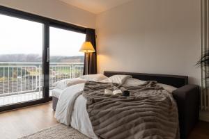 a bedroom with a bed and a large window at Hillebachsee in Winterberg