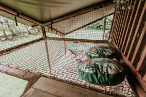 a bird cage with two green balls in it at Kampari in Delfstrahuizen