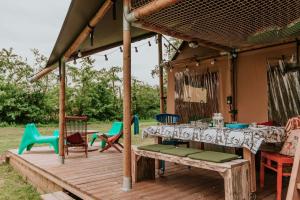 a wooden deck with a table and chairs at Kampari in Delfstrahuizen