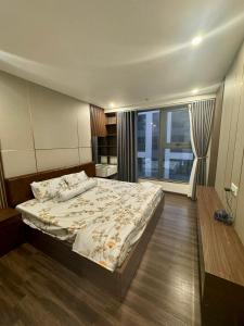 a bedroom with a large bed and a large window at Hoang Huy Grand Tower - Apartment - Homestay in Hai Phong