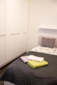 a bedroom with a bed with two towels on it at Lahti Furn House in Lahti