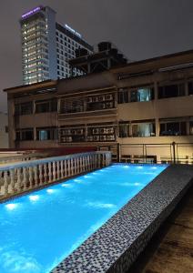 a swimming pool in front of a building at night at Bestow Boutique Hotel in Kuala Lumpur