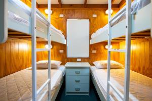 a bunk bed room with two beds and a mirror at Joalah Holiday Park in Durras