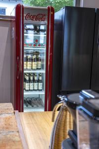 an open cocacola refrigerator filled with lots of beer at Landurlaub mit neugierigen Blicken in den Pferdestall, eingezäuntem Garten, Kamin und Sauna in Rot am See