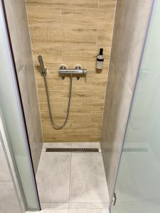 a shower in a bathroom with a hose at Borsa Rooms in Mostar