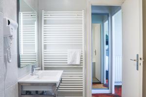 a bathroom with a sink and a mirror at Hotel De La Digue in Le Mont Saint Michel +26 photos
