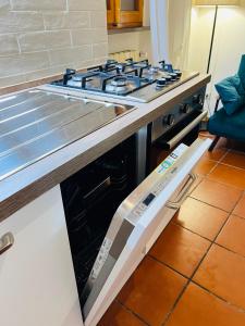a stove top oven sitting in a kitchen at Il cretto bianco in Città di Castello