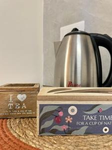 a tea kettle and a box on a table at LA TORRE SARACENA - HOLIDAY HOUSE with services in Palmi