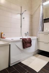 a bathroom with a shower and a tub with a towel at Modern Charm Hideaway in Zagreb