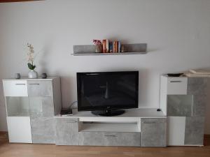 a tv sitting on a white entertainment center at Ferienwohnung Josef in Steyr
