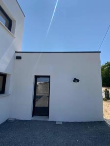 a white building with a blue light on it at T1 ( Saint-Jean-de-Monts ) calme et central in Saint-Jean-de-Monts