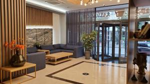 a living room with a couch and a table at Hotel Salvador in Batumi