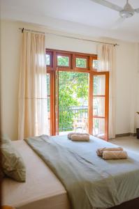 a bedroom with a large bed with two pillows on it at The Native Weligama in Weligama
