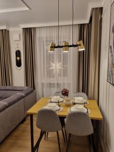 a living room with a table and chairs and a couch at Good Mood Apartment in Klaipėda