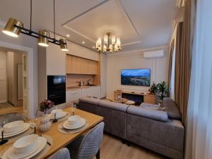 a living room with a couch and a table at Good Mood Apartment in Klaipėda