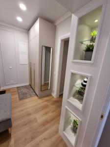 a living room with white walls and wooden floors at Good Mood Apartment in Klaipėda +40 photos
