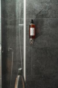 a bottle of soap is hanging on the wall of a shower at Hotel Ines in Cattolica