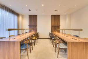 a conference room with long tables and chairs at Livensa Living Studios Bilbao in Bilbao