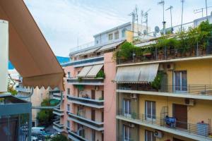uma vista para um edifício de apartamentos com varandas em Casa de Colores, next to the metro em Atenas