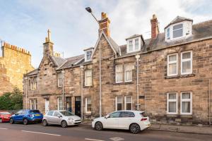 two cars parked in front of a brick building at St Andrews - 5 min walk to centre in St Andrews