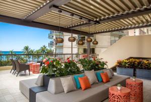 a patio with a couch and some plants at Aston Waikiki Beach Tower in Honolulu