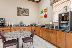 a kitchen with a table and a counter with a microwave at Quality Inn & Suites South in Obetz